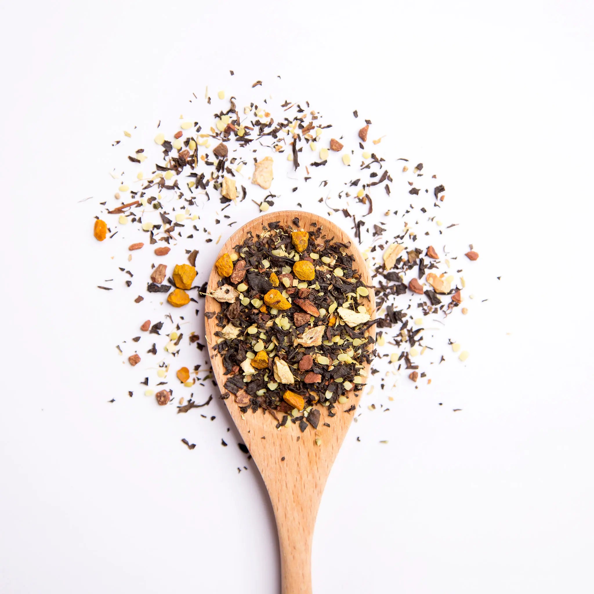 A wooden spoon with loose leaf tea